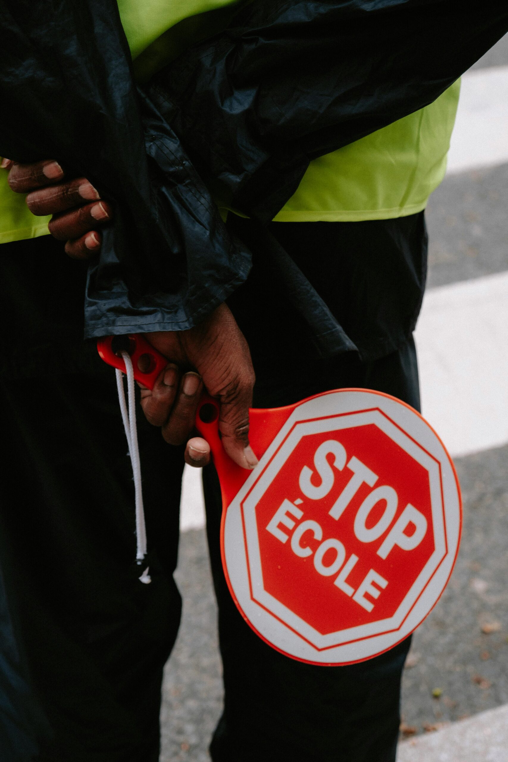 Person Holding Red and White Stop Sign